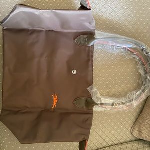 A small unused olive green longchamp bag.